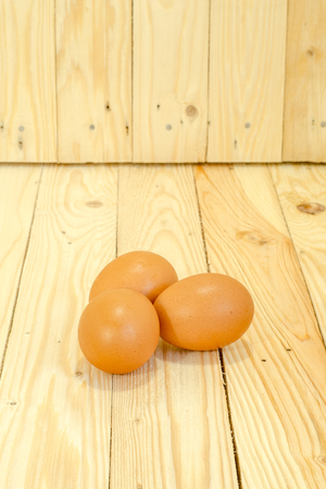 Three eggs on the wooden floorの写真素材