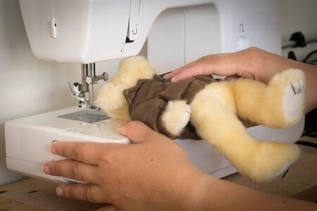 Repair doll with a sewing machineの写真素材