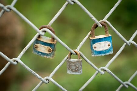 blur The padlock keys at the same fence .This means that love is not divided .But there is one between the Interferences in the middle.の写真素材