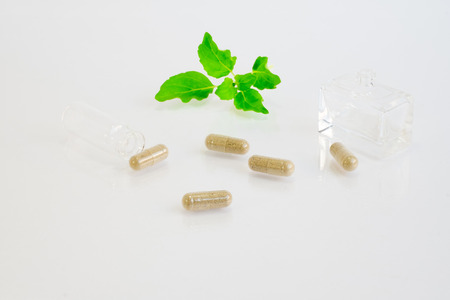 herb pills  on white backgroundの写真素材