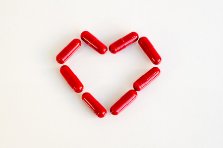 Red heart pill .Represents medication for heart diseaseの写真素材
