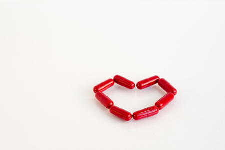 Red heart pill .Represents medication for heart diseaseの写真素材