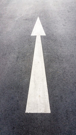 Arrows on asphalt road surface. Forward signs on the road