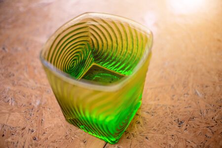 Green Glass with water on a wooden table.の写真素材