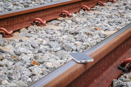 Lost Phone.The phone  dropped and fell to the railroad tracks .の写真素材