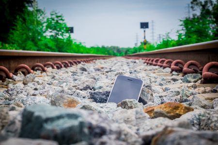 Lost Phone.The phone  dropped and fell to the railroad tracks .の写真素材