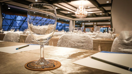 Glass of water in the seminar. Image of workplace and paper ready for indoor business conference.