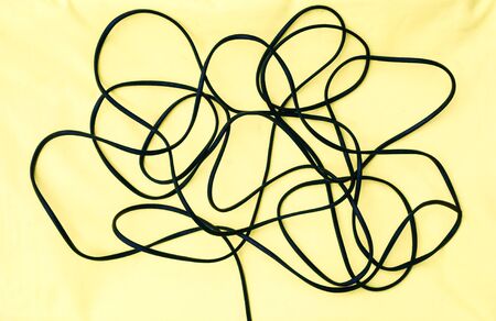 cables and wires Black electric power supply cable On a yellow background . Power lines curled like a tree. means Mixed technology and Eco Save environment.の写真素材