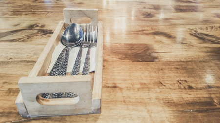 Spoon and fork on wooden table surface, empty spaceの写真素材