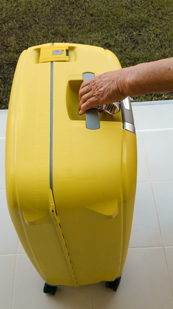 Senior older hands woman handle Bag traveling luggage .の写真素材