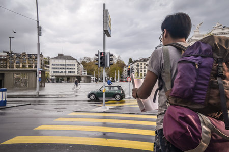 Travel concept . Asian Tourists backpack opening the map in During a trip to through Europe.