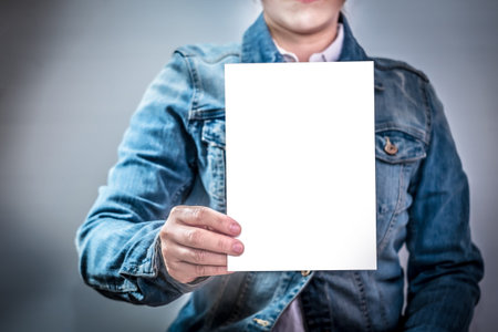 Business women holding white paper or label Applied for , brochure, mock up , blank card , poster ....