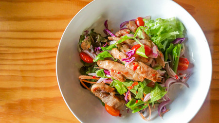Spicy BBQ Pork Salad .  grill pork with mixed vegetable spicy taste at Thai styled foodの写真素材