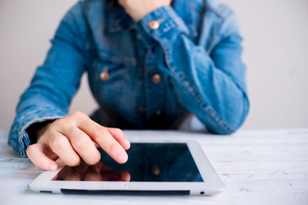 Attractive Modern business woman Hand Touching and Using Digital tablet Screen . Analyst Department Researching Process . Young Girl Working New Startup .の写真素材
