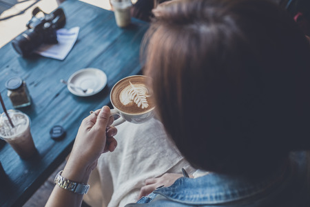 Happy business young woman taking selfie with Smart Phone Enjoyment with Cappuccino coffee and relax In her holiday .の写真素材