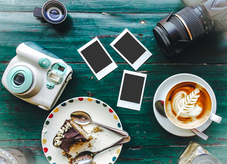Top View on the table which Cup of Hot Cappuccino coffee and photo Cameraの写真素材