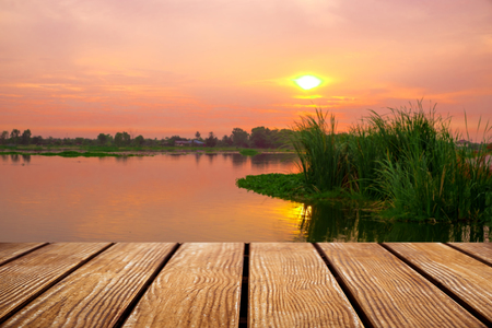 Empty Old Wooden table with River during sunset background .の写真素材