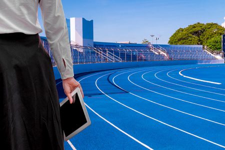 business Football Manager woman working Using tablet on the Sports stadium . happy at work Concept .の写真素材
