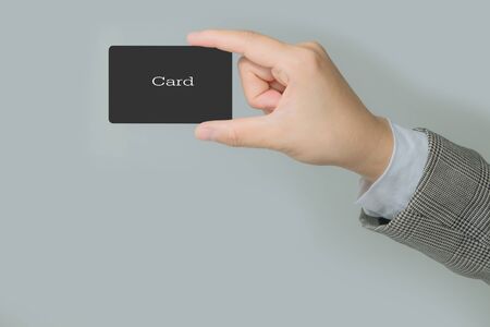 Hands is holding  business card or black label  in office .の写真素材