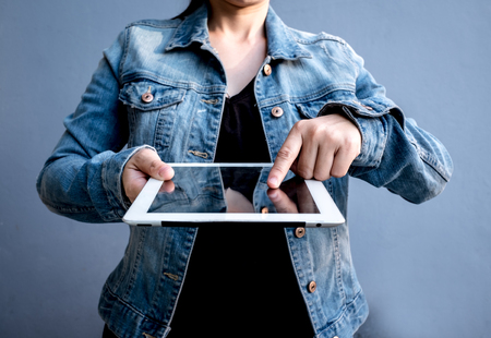Attractive Modern business woman Hand Touching and Using Digital tablet Screen . Analyst Department Researching Process . Young Girl Working New Startup .の写真素材