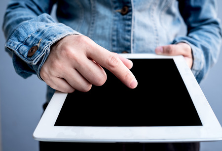 Attractive Modern business woman Hand Touching and Using Digital tablet Screen . Analyst Department Researching Process . Young Girl Working New Startup .の写真素材
