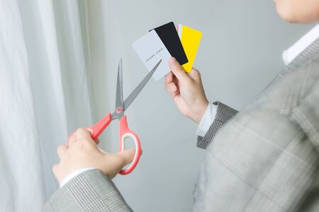 businessman cutting up credit card with scissors over contract and other . Destroy for protection moneyの写真素材
