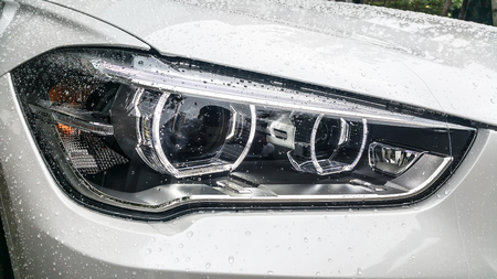 Modern car headlights Front of White car On the day of wet wipers. Garage Themeの写真素材