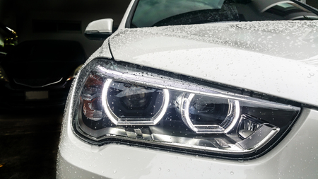 Modern car headlights Front of White car On the day of wet wipers. Garage Themeの写真素材