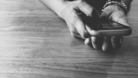 Hands using smart Phone on tableの写真素材