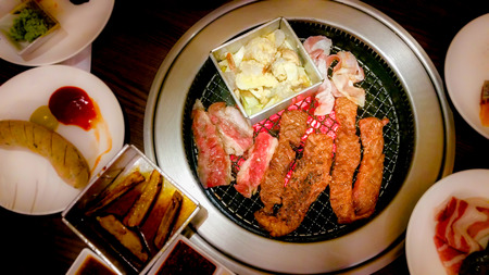 Meat grilled on charcoal stove and marinated pork ,beef slices with ingredients for cooking grilled BBQ Korean and Japanese food , Recommended dishes in Asian cuisine .の写真素材