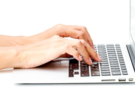 woman hand typing on the laptop on white table