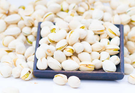 pistachio nuts :The pistachio, a member of the cashew family, is a small tree originating from Central Asia and the Middle East. The tree produces seeds that are widely consumed as foodの写真素材