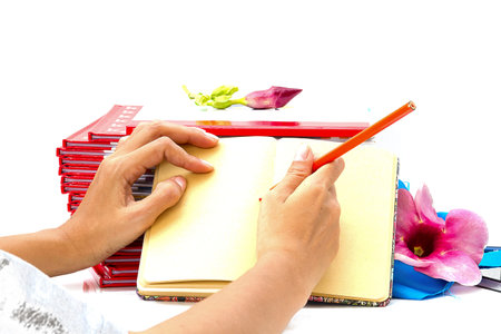 woman hand holding pen writting on book