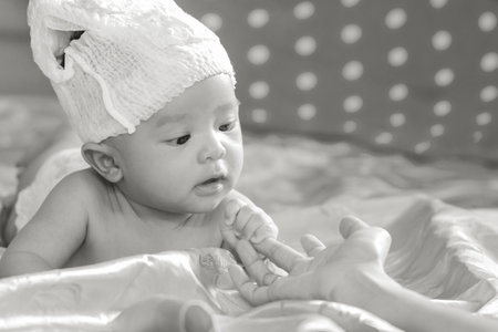 adorable little boy with pamper on head,little boy in bedroom. Newborn child relaxing in bed....