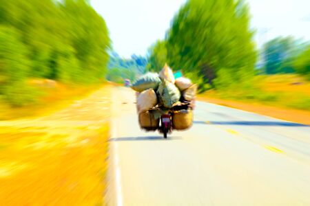 Overload motorcycle speeds on the road.の写真素材