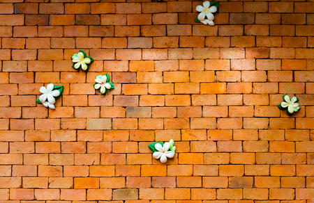 Brick wall background with flowersの写真素材