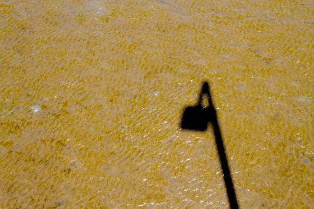 Shadow of the power pole on sandの写真素材