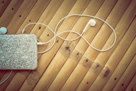 Headphones on a wooden tableの写真素材