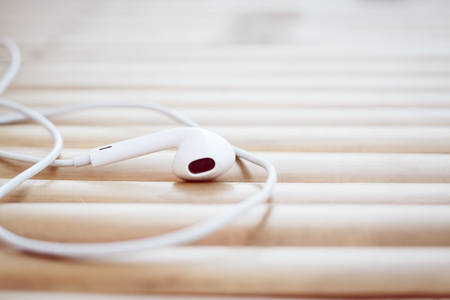 Headphones on a wooden tableの写真素材