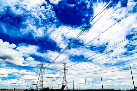 high voltage power lines and high voltage poles. Under the beautiful sky.の写真素材