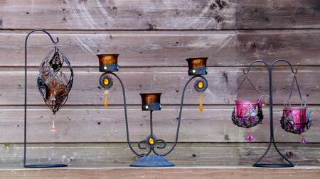 Candlestick support or holder for one or more candles, typically one that is tall and thin with wooden background .の写真素材