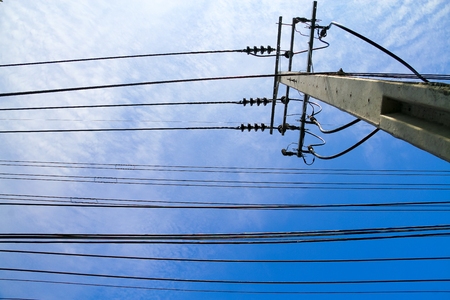 Electric pole with electric cable on the blue sky backgroundの写真素材