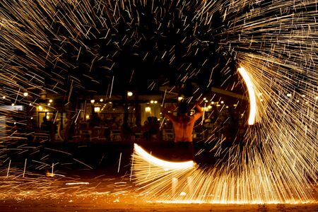 Fire dancers Swing fire dancing show fire show on the beach dance man juggling with fireの写真素材