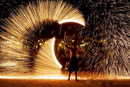 Fire dancers Swing fire dancing show fire show on the beach dance man juggling with fireの写真素材
