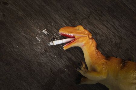 Smoking dinosaur : Smoking is harmful to health.の写真素材