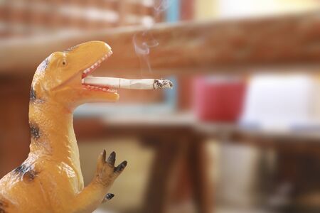 Smoking dinosaur : Smoking is harmful to health.の写真素材
