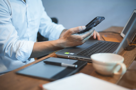 Businessman in white shirt using mobile smart phoneの写真素材