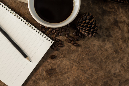 Work with a notebook and have coffee on the wooden floor.の写真素材