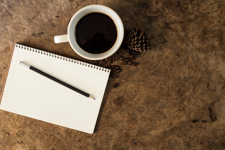 Work with a notebook and have coffee on the wooden floor.の写真素材