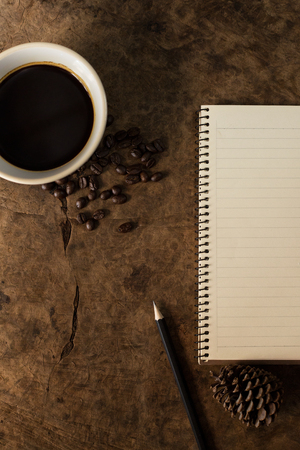 Work with a notebook and have coffee on the wooden floor.の写真素材